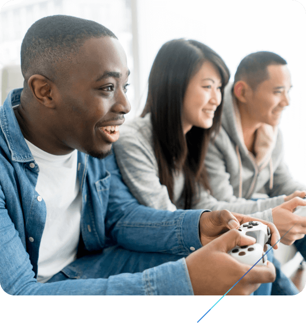 Three smiling people playing a video game together