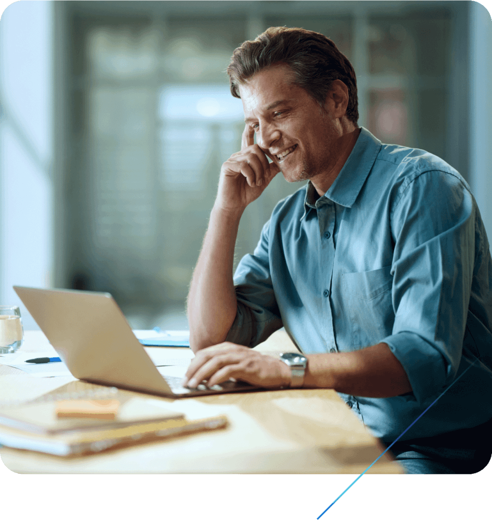Person using a laptop in an office meeting room.