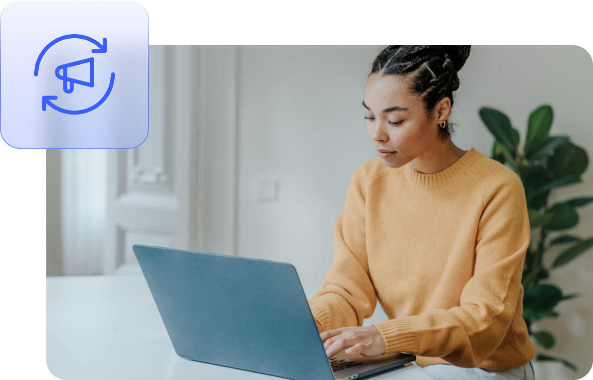 Person typing on a laptop in a home office.