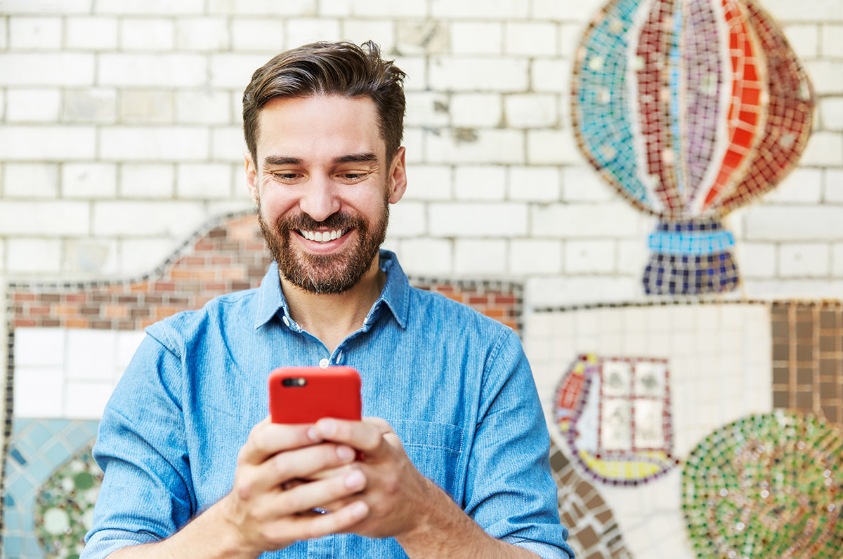 Male using a red smart phone